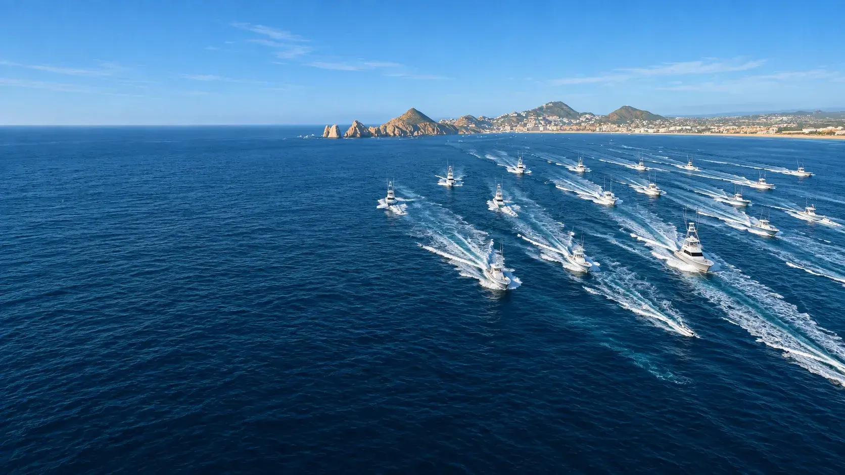 Aerial view of a sportfishing fleet running offshore at a tournament start